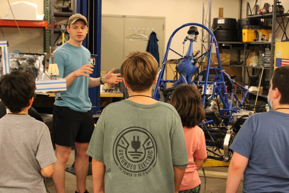 Students learn about Formula SAE from an engineering student